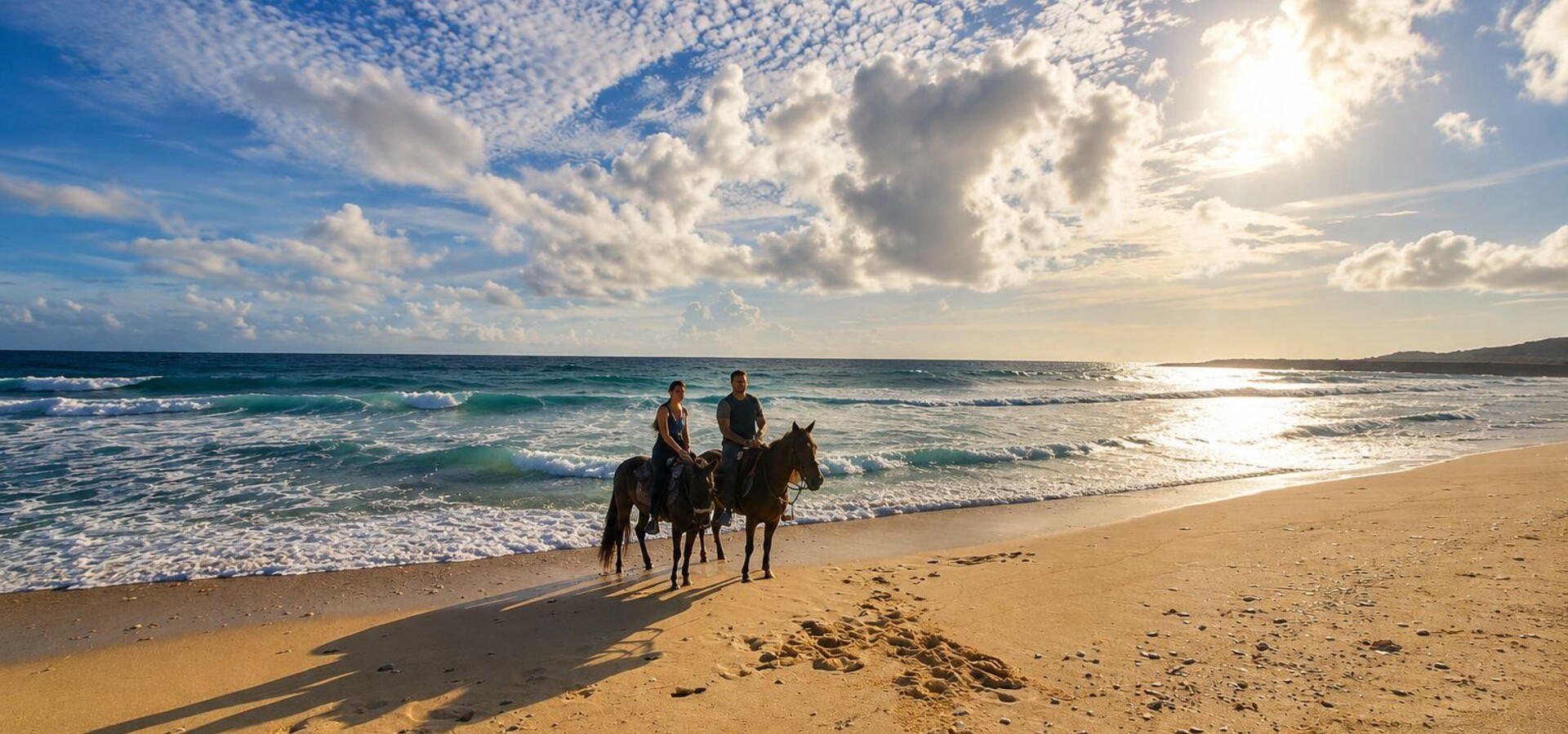 Couple on 2 horses at the beach